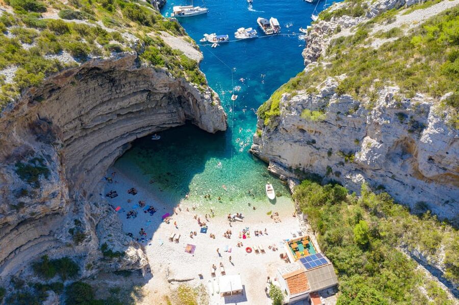 From Hvar: Blue cave group speedboat tour full day - Stiniva Cove brings cliffs and a close look at the coast