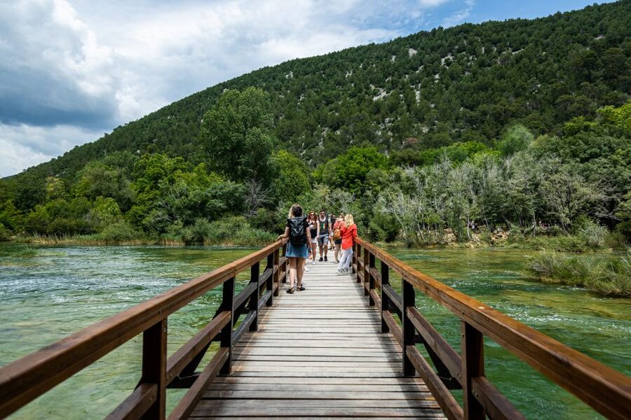 Split: Krka National Park Day Trip with Boat Ride & Swimming - Walking the waterfall trails at Krka